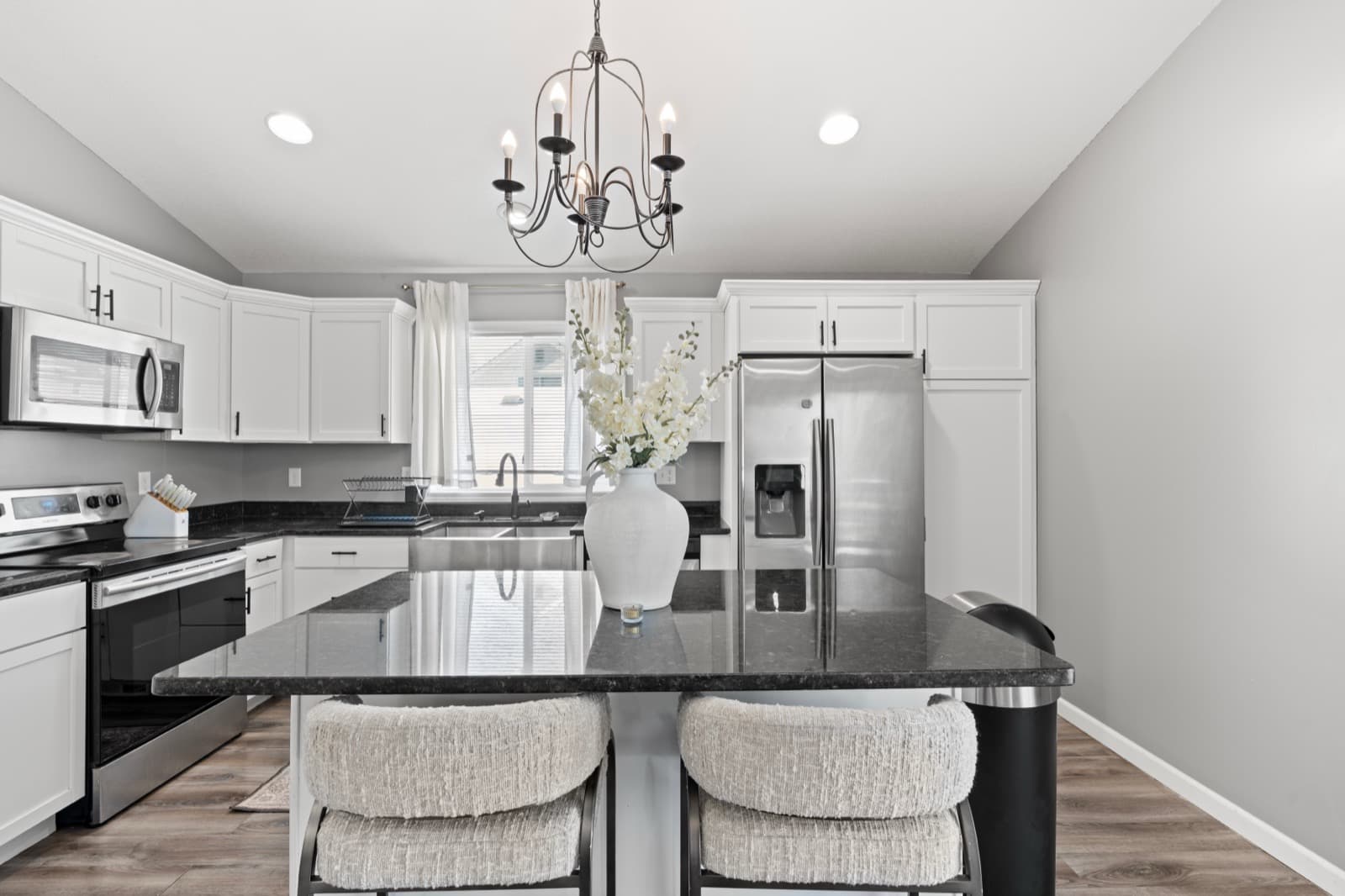 The kitchen island under a chandelier