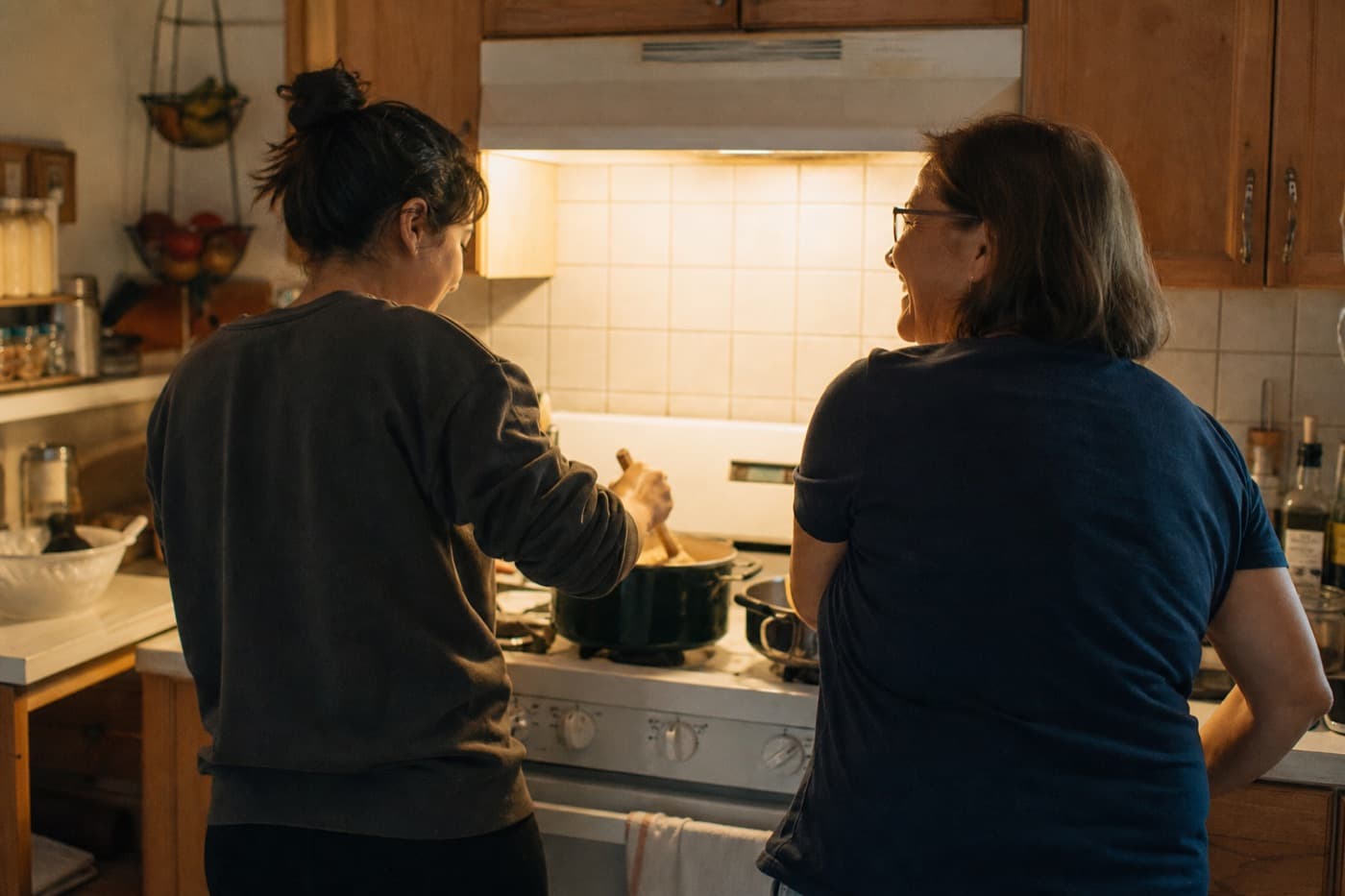 Two people cooking together at the stove