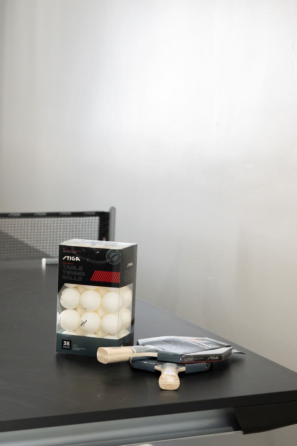 Table tennis balls and paddles on the ping-pong table